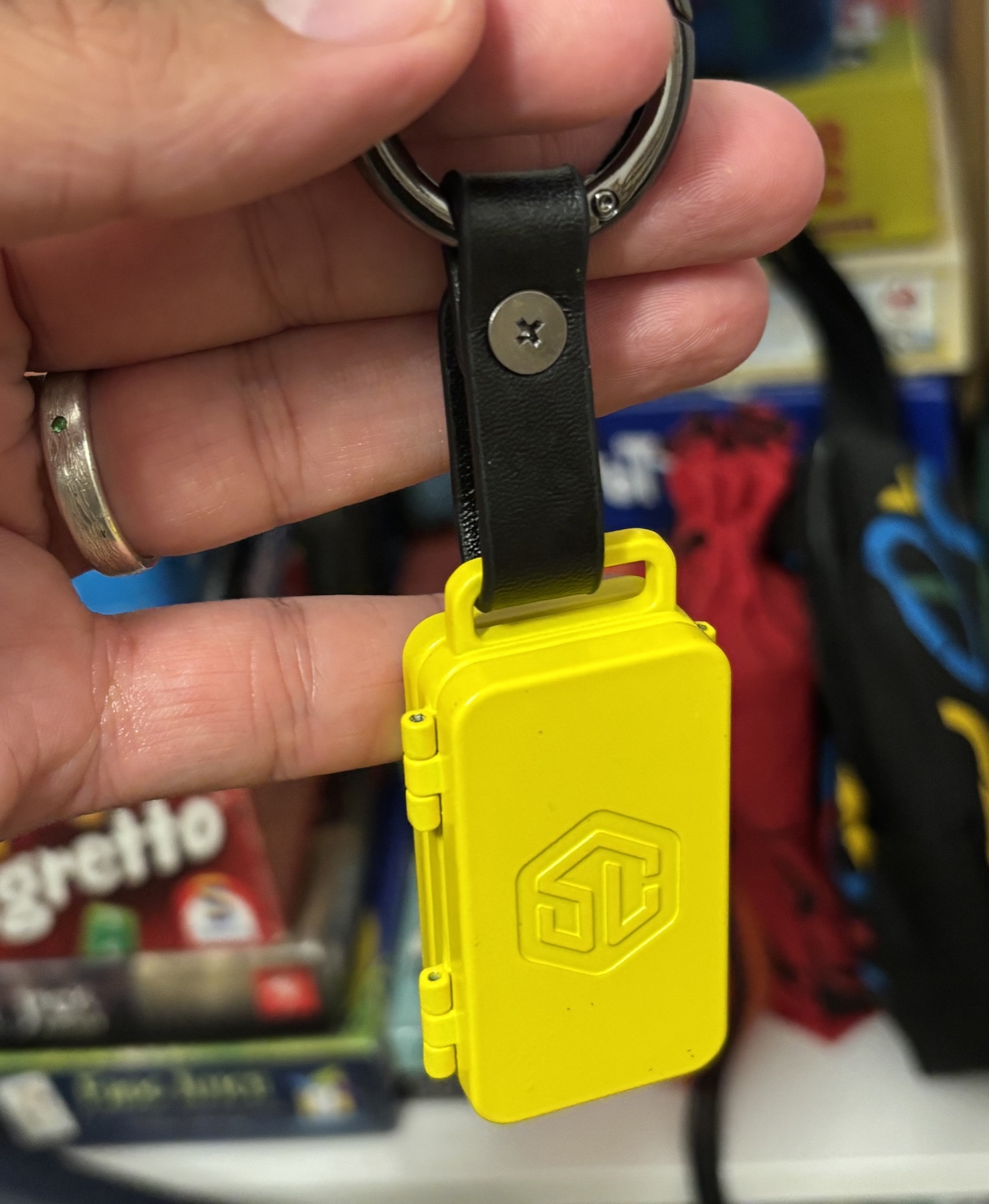 The closed yellow Cardyhedron Fold case attached to a key ring